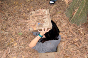 Getting into a tunnel of Cu Chi Tunnels