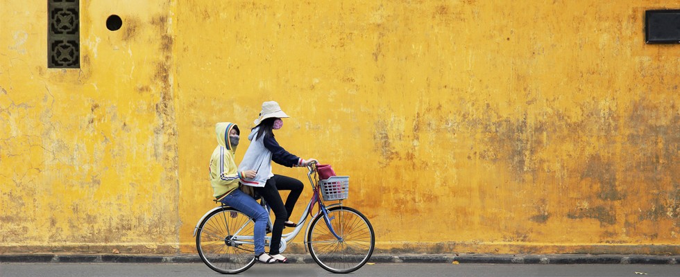 Two girls riding a bike in the Old Quarter of Hanoi