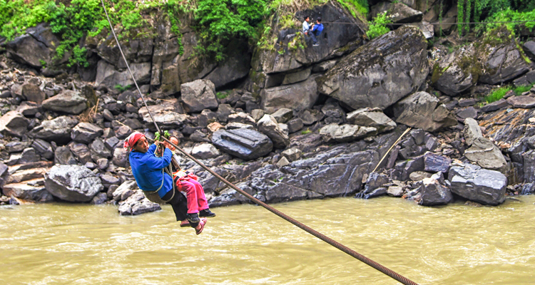 a woman on the zipline across the river